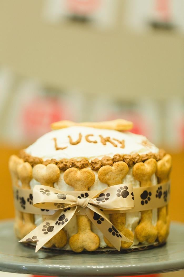 Bone Wrapped Barkday Cake for dogs, decorated with biscuits and a paw print ribbon, perfect for celebrations.