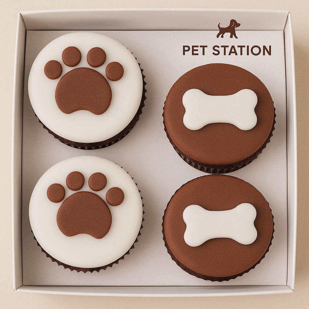 Pack of 4 pet-themed cupcakes from Pet Station featuring paw and bone designs.