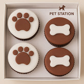 Pack of 4 pet-themed cupcakes from Pet Station featuring paw and bone designs.